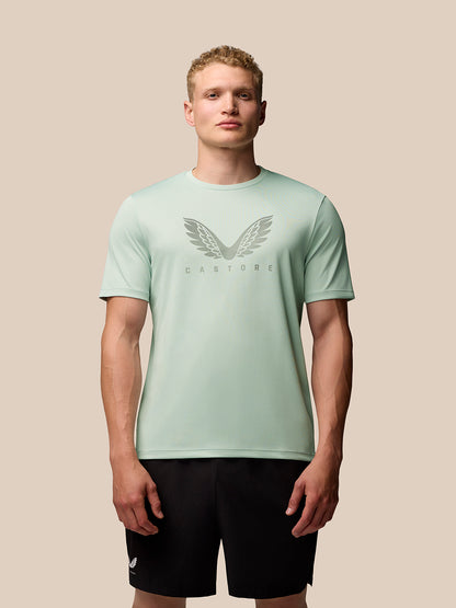 Male model wearing mint green Adapt Training T-Shirt with wing graphic on chest