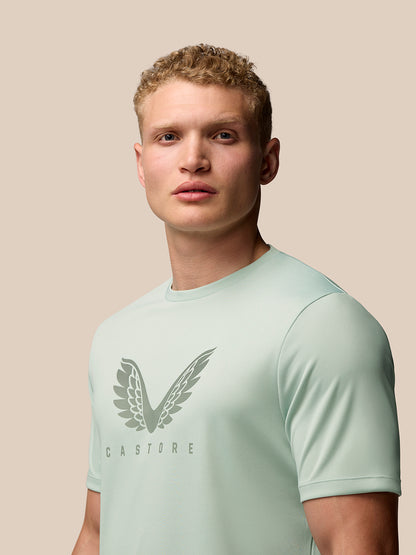 Male model wearing green Adapt Training T Shirt with Castore wings graphic on the chest