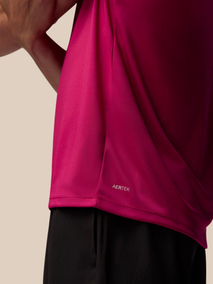 Close up of pink Adapt Training T-Shirt fabric near the lower back hem with AerTek branding.