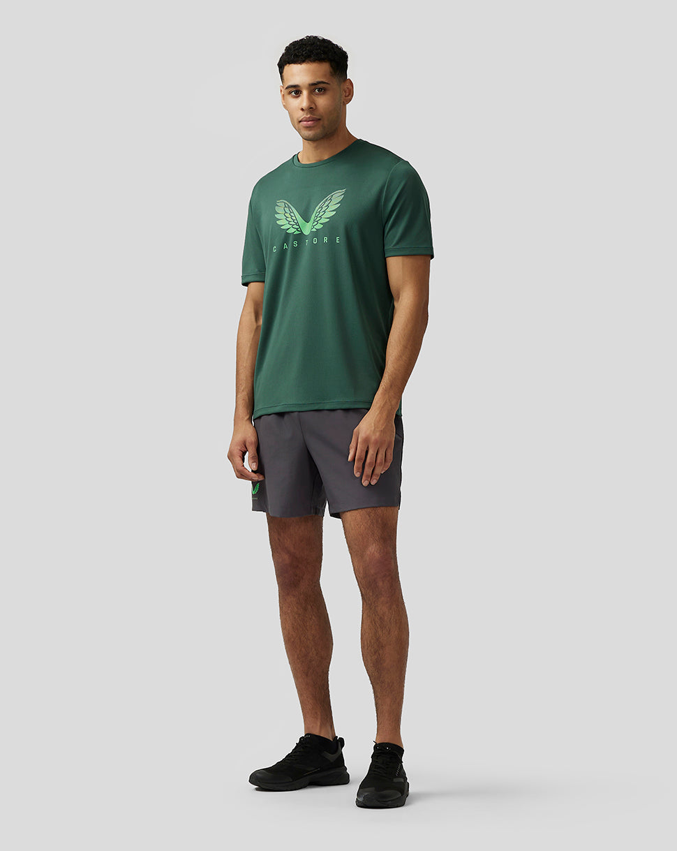 Man wearing green Adapt Training T Shirt with Castore wings chest graphic paired with dark shorts