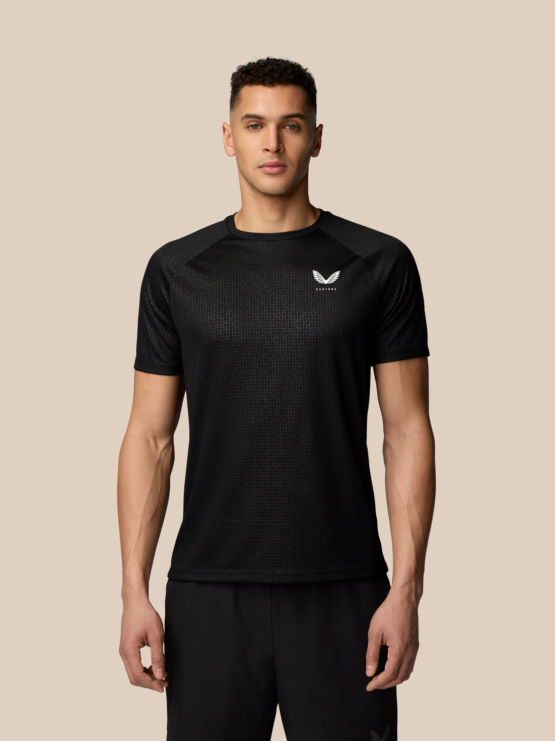 Front view of a male model wearing black Adapt Training T Shirt with Castore branding on the chest.