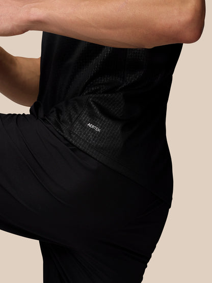 Close up of the side torso showing Aertek label and grid pattern on black Adapt Training T Shirt.