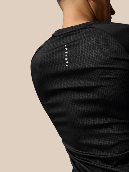 Rear view of black Adapt Training T-Shirt showing vertical Castore branding on shoulder and geometric print.