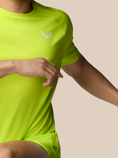 Side view of male model in neon lime Adapt Training T-Shirt featuring Castore logo on chest.