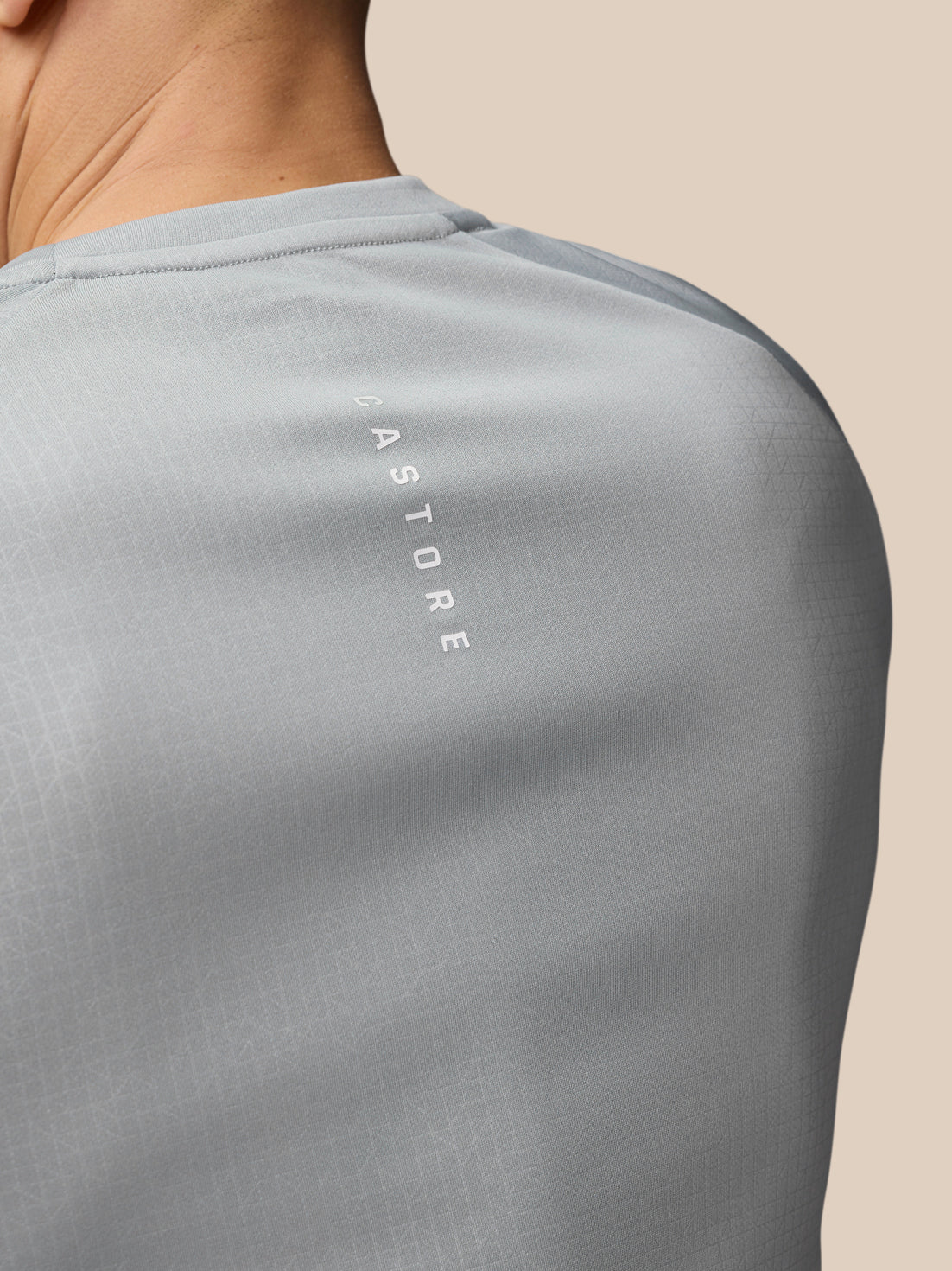 Back view of Adapt Training T Shirt mid grey highlighting vertical Castore branding along the upper back.
