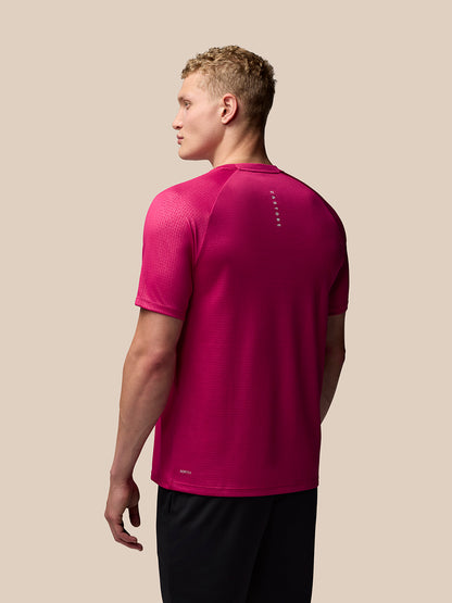 Back view of pink Adapt Training T Shirt with geometric pattern and Castore branding along the upper back and AerTek branding at the lower left back
