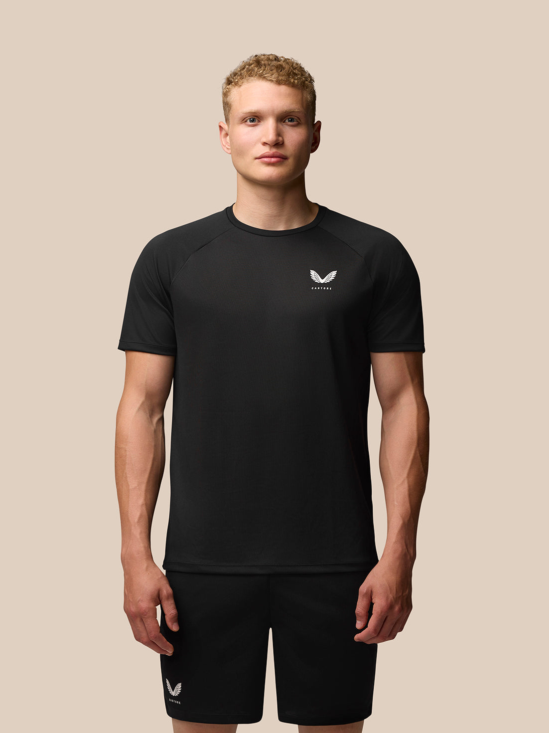 Front view of a man wearing black Adapt Training T Shirt with white Castore logo on the left chest