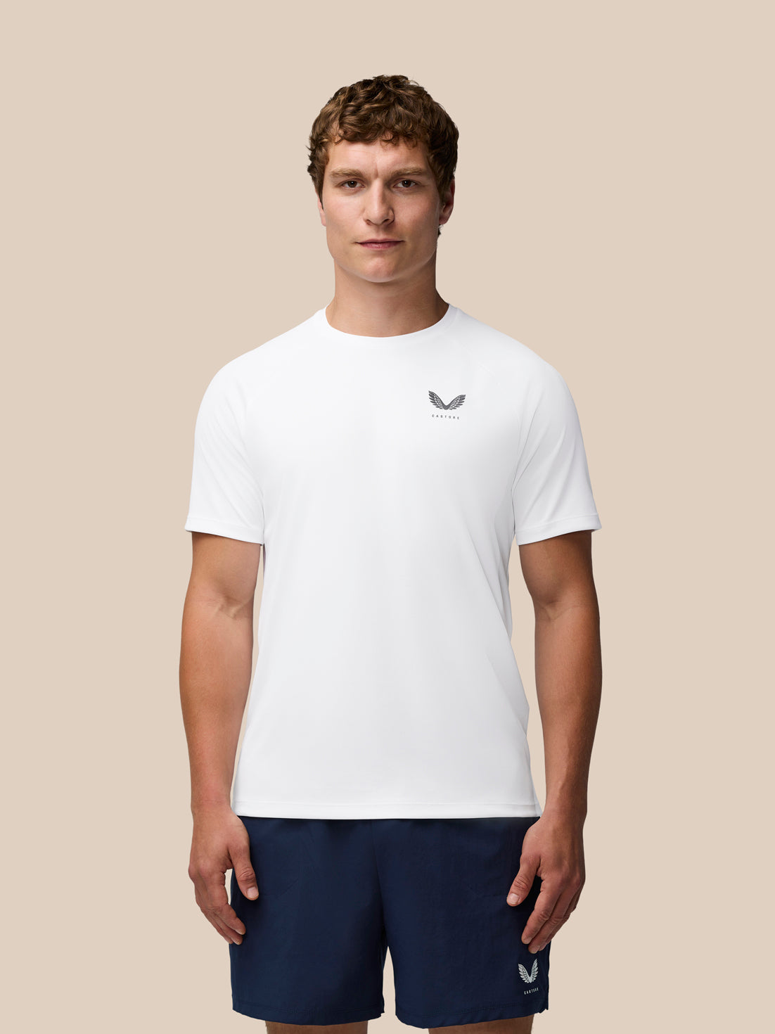 Male model wearing white Adapt Training T-Shirt with Castore logo on the chest.