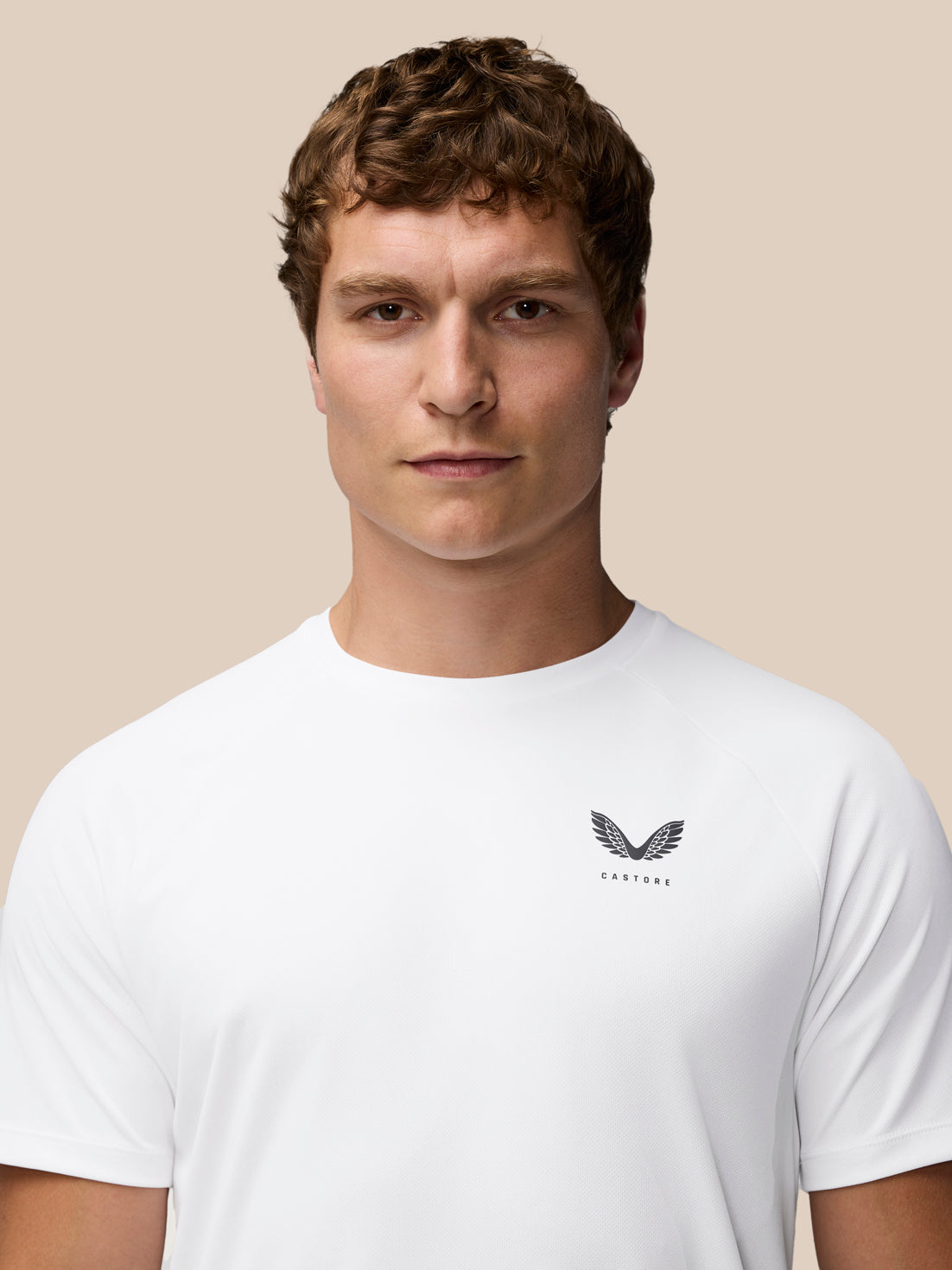 Portrait of a man in a white Adapt Training T-Shirt with Castore logo on chest.