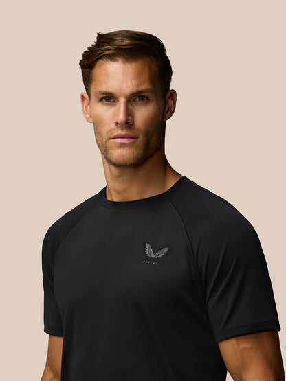 Close up of a black Adapt Training T Shirt on a male model showing a subtle Castore logo on the left chest.