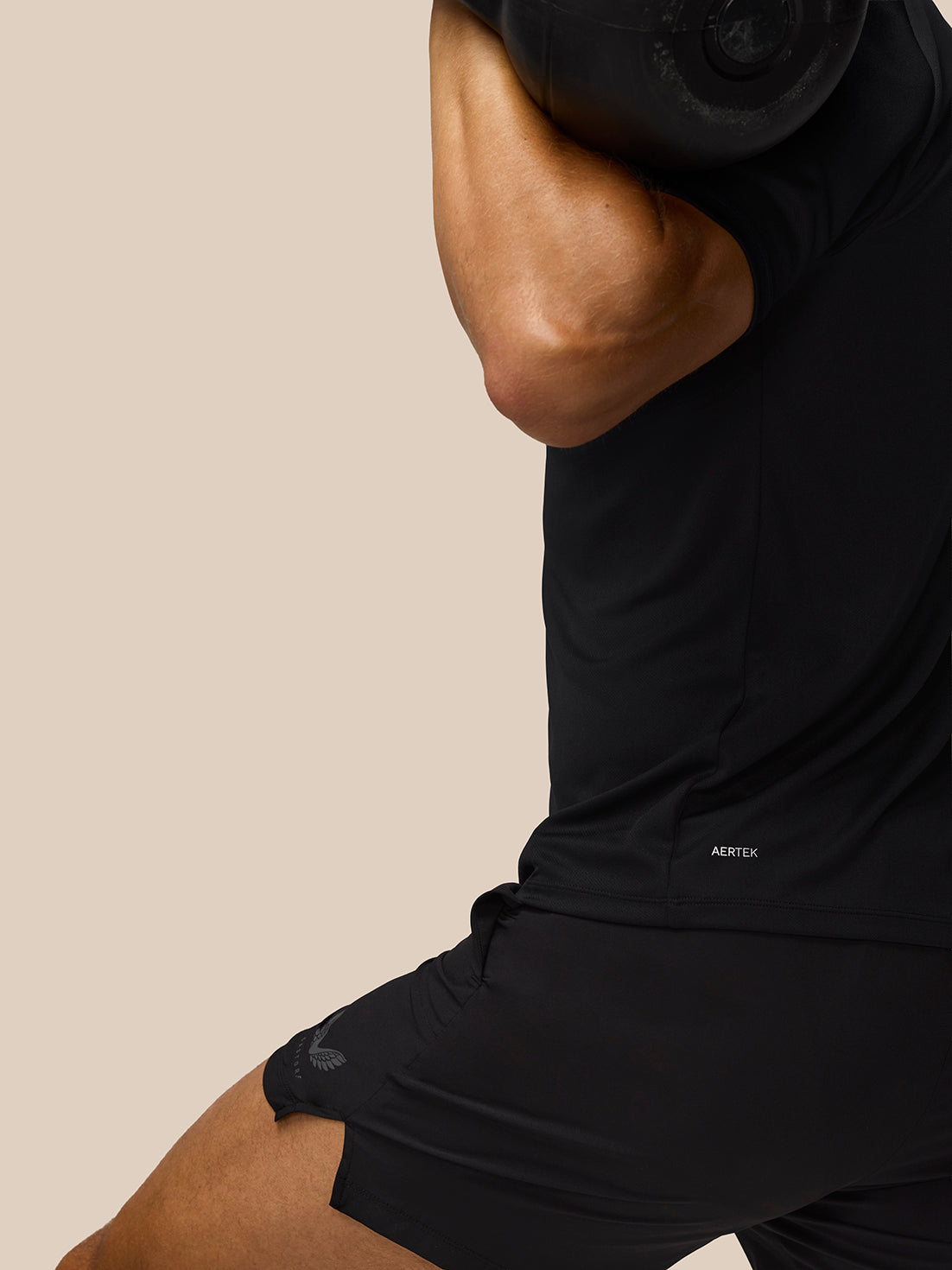 Model wearing black Adapt Training T Shirt with AERTEK label on lower back