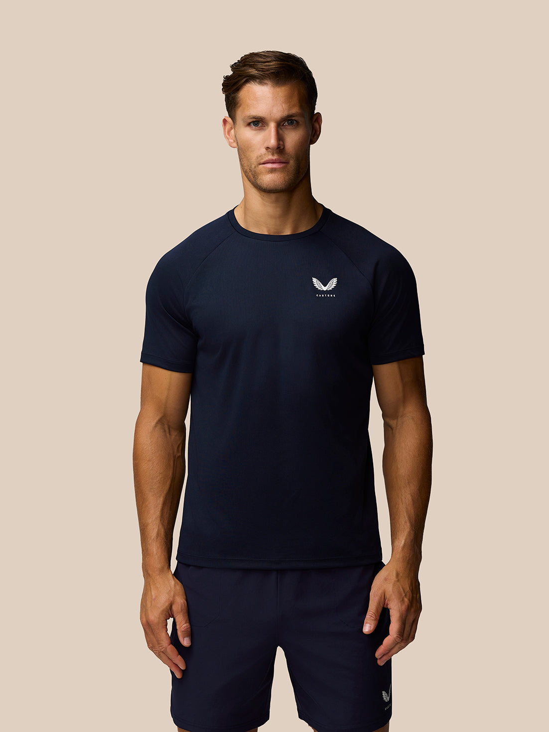 Male model wearing Adapt Training T-Shirt in Midnight Navy with Castore logo on the chest