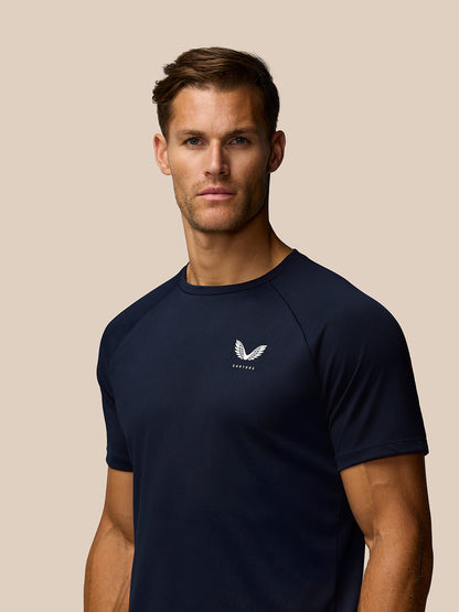 Male model wearing midnight navy Adapt Training T-Shirt with white Castore logo on the chest.