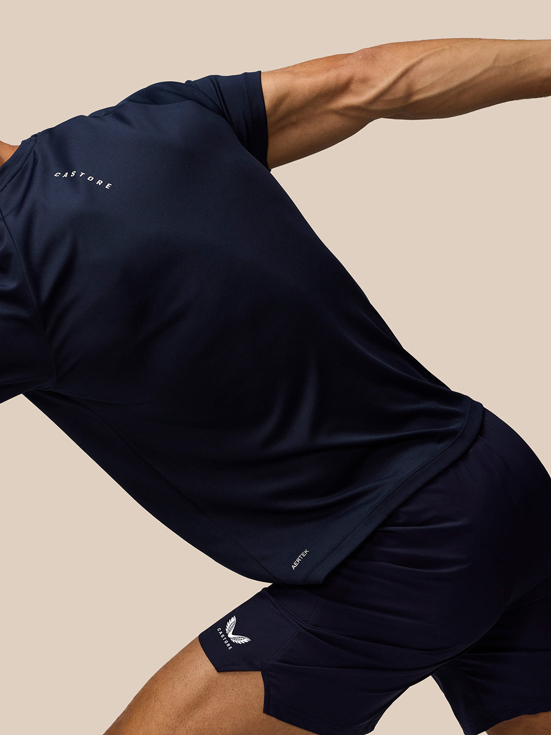 Athlete in navy Adapt Training T-Shirt in motion with Castore branding on the sleeve