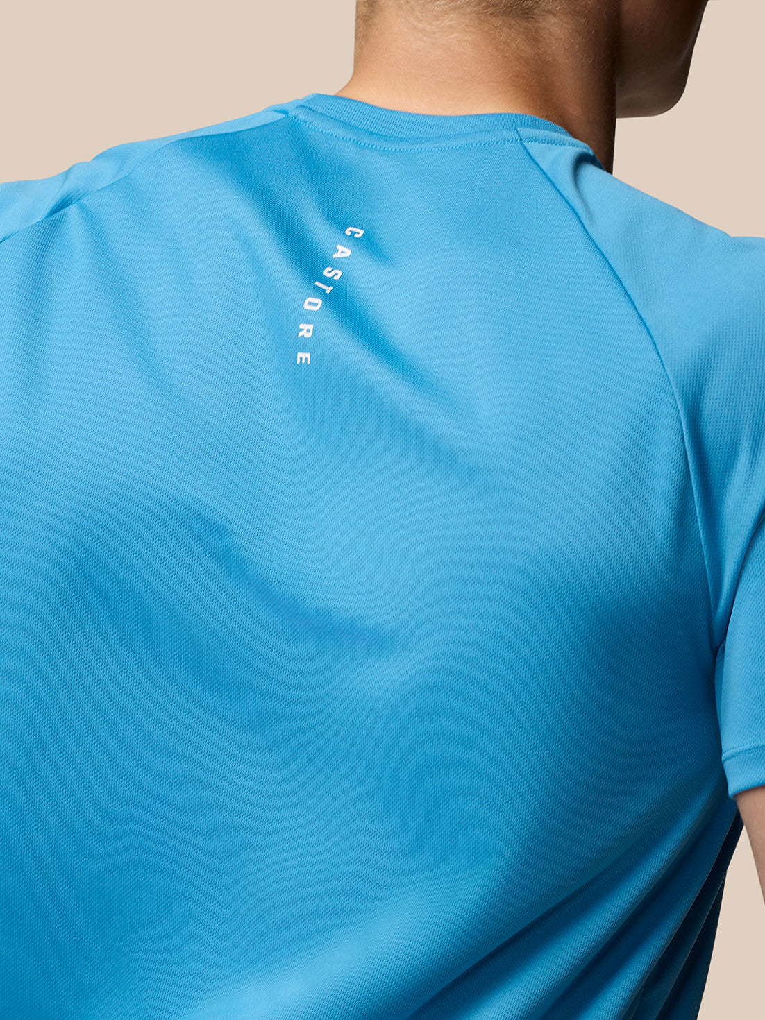Back view of corn blue Adapt Training T-Shirt with vertical Castore branding along the back.