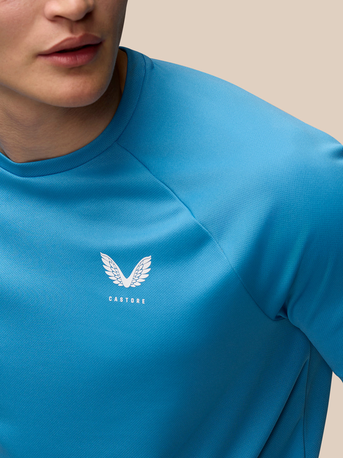Close-up of corn blue Adapt Training T-Shirt front with Castore logo on left chest.