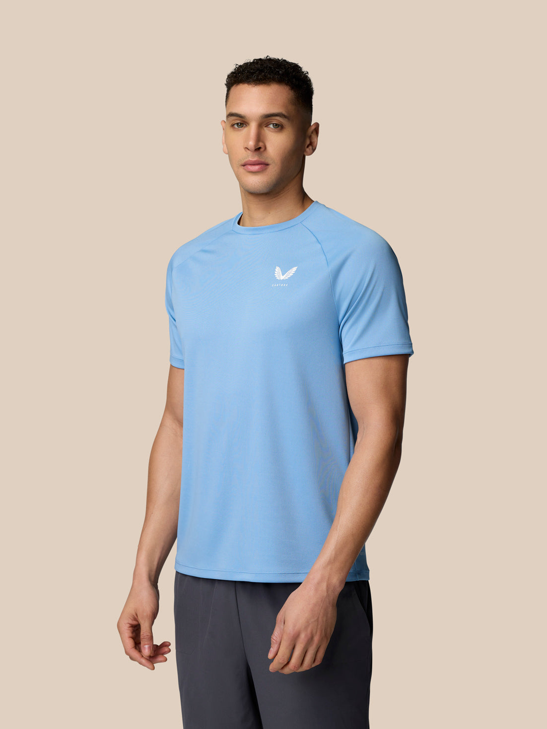 Male model wearing sky blue Adapt Training T-Shirt front view with Castore logo on chest