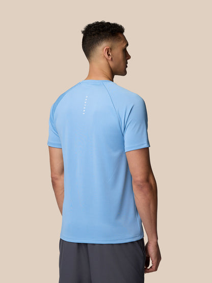 Back view of male model wearing sky blue Adapt Training T-Shirt with Castore branding on upper back
