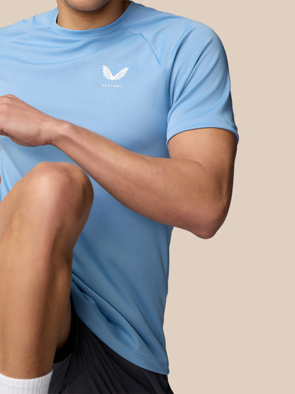 Upper torso of a model wearing sky blue Adapt Training T Shirt with Castore logo on the chest