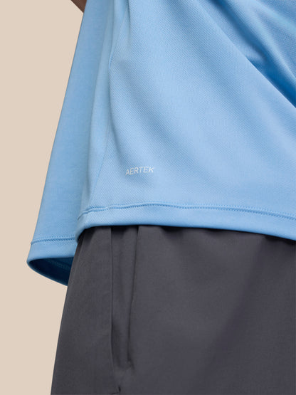 Side view of sky blue Adapt Training T Shirt showing AERTEK branding near the hem