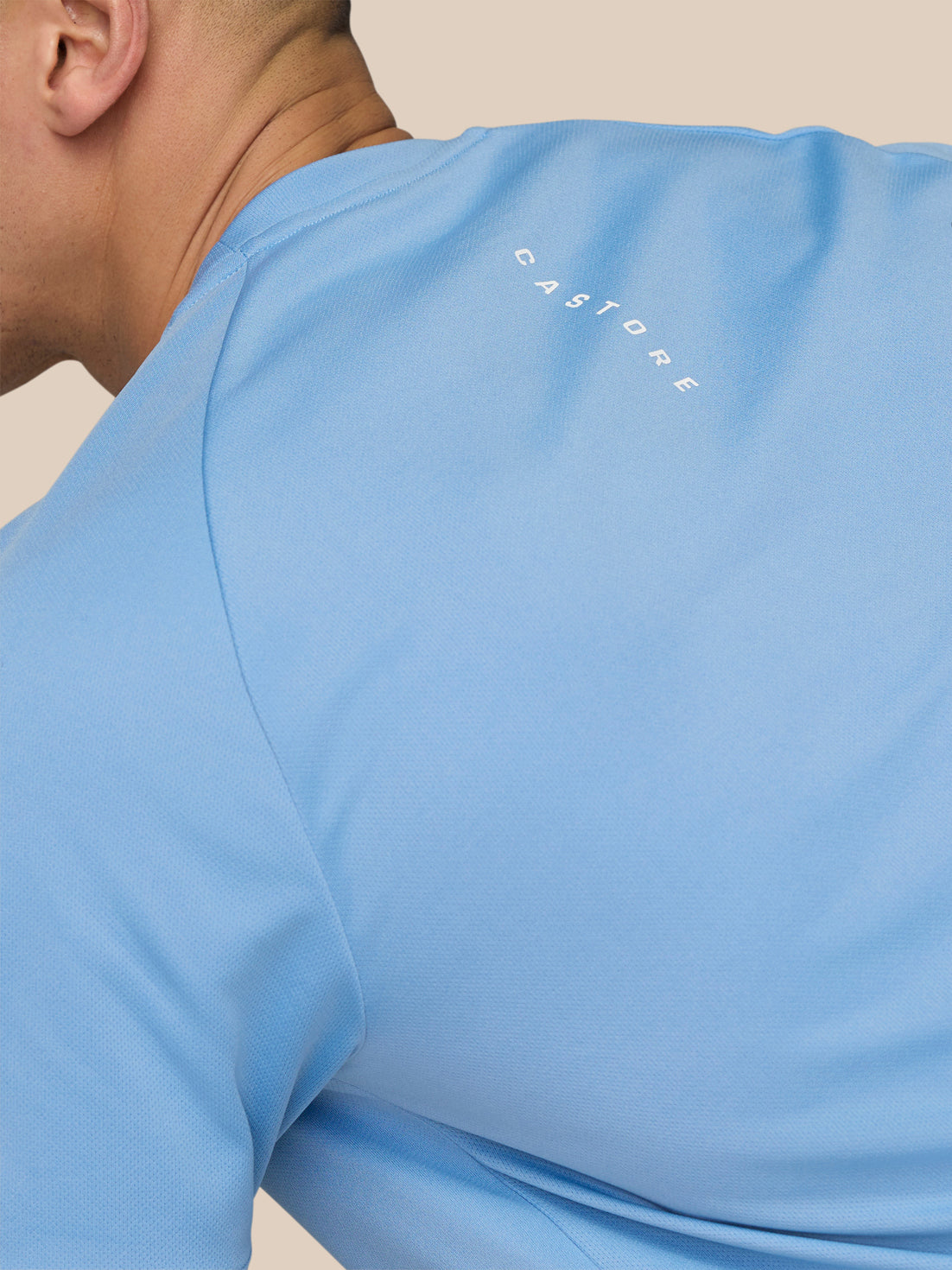 Close up of sky blue Adapt Training T Shirt shoulder with Castore branding along the upper back