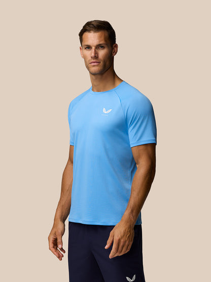 Light blue Adapt Training T-Shirt on male model front view with AerTek sweat-wicking fabric and Castore logo on left chest.