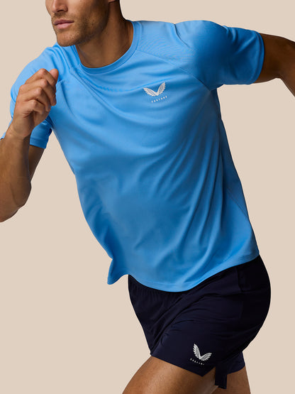 Male model wearing light blue Adapt Training T Shirt with Castore logo on the left chest and visible raglan sleeve seam