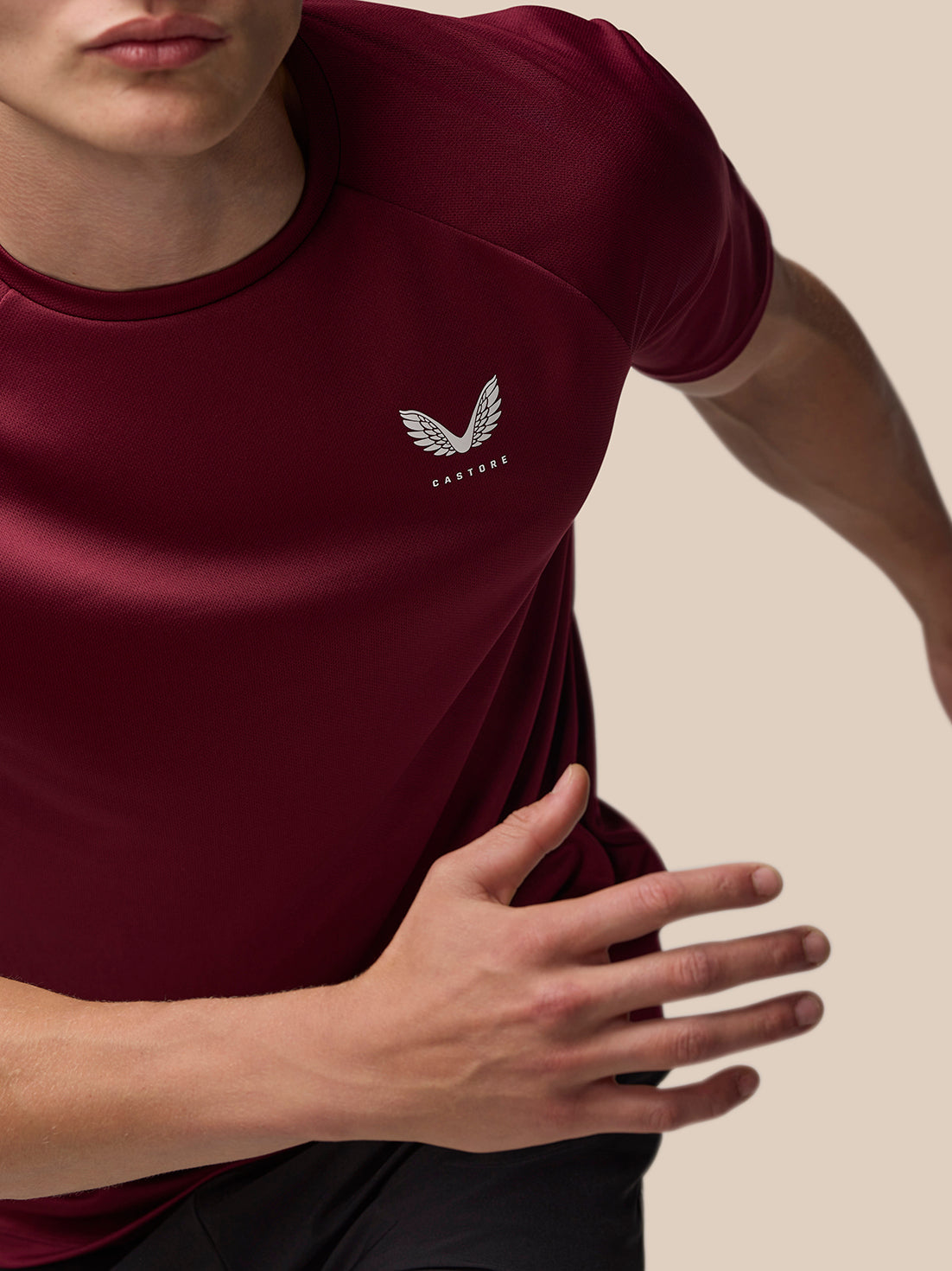 Close-up of burgundy Adapt Training T-Shirt with white Castore wing logo on the left chest