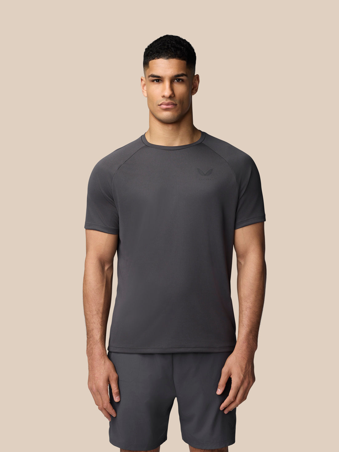 Male model wearing a Gunmetal Adapt Training T-Shirt with crew neck and raglan sleeves