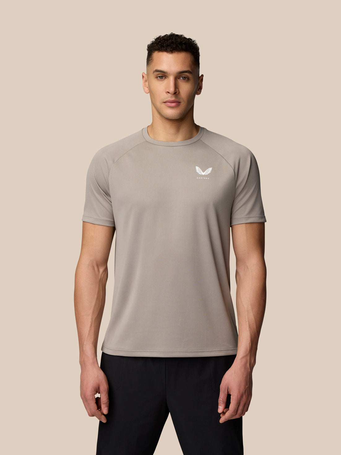 Male model wearing light grey Adapt Training T-Shirt facing forward with Castore logo on the chest