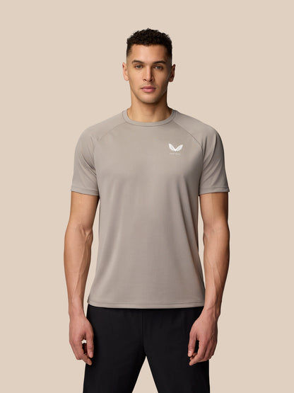 Male model wearing light grey Adapt Training T-Shirt facing forward with Castore logo on the chest