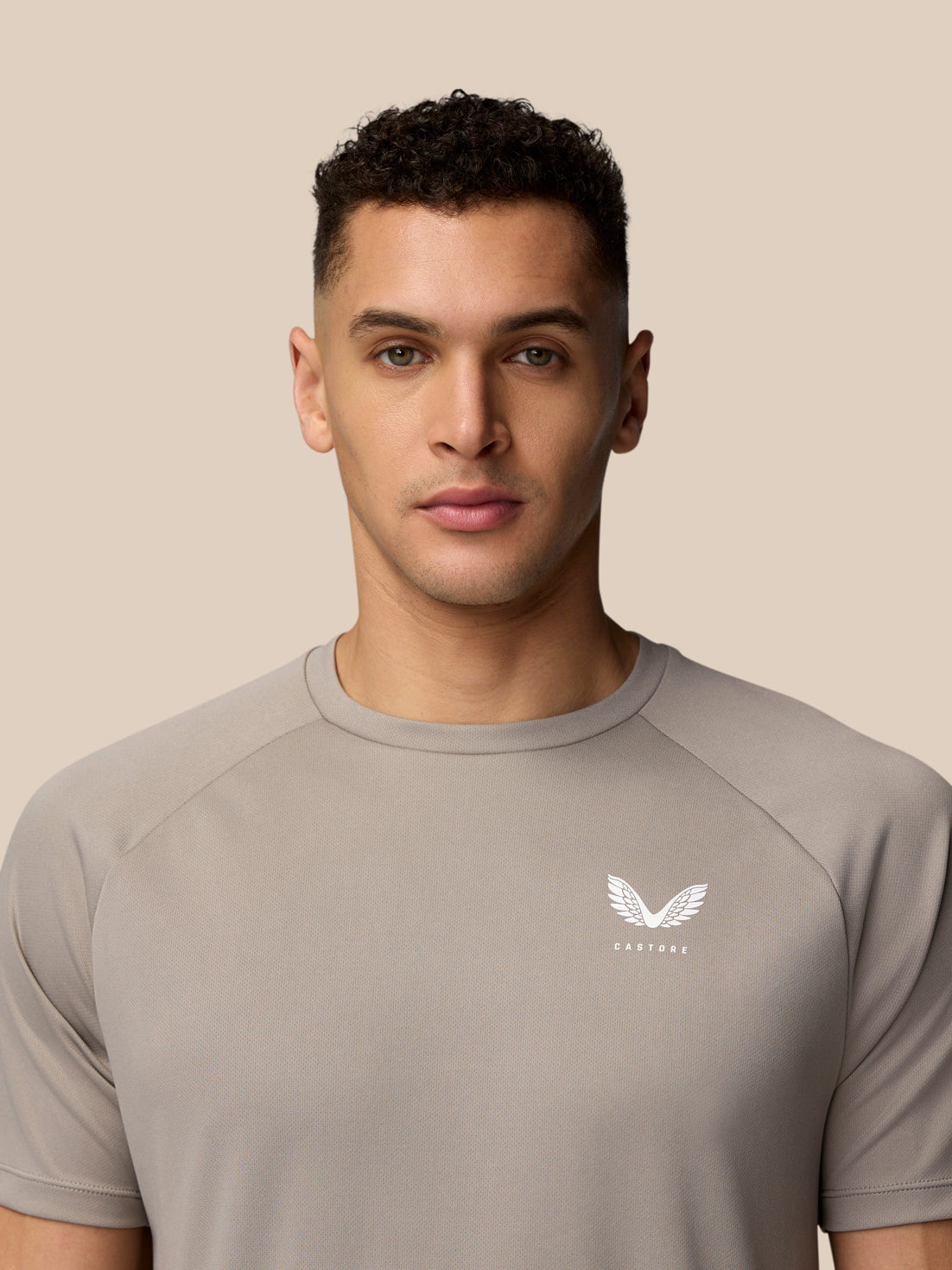 Close-up of left chest on light grey Adapt Training T-Shirt showing the Castore logo
