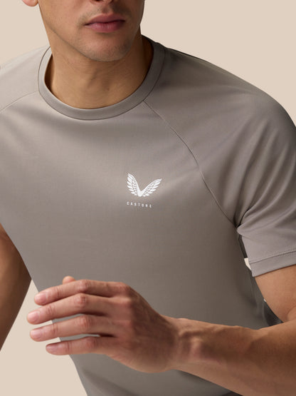 Close up of light grey Adapt Training T-Shirt showing Castore logo on the chest and raglan sleeve seam