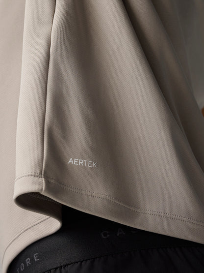 Close up of beige fabric at the sleeve with AERTEK branding on the Adapt Training T-Shirt