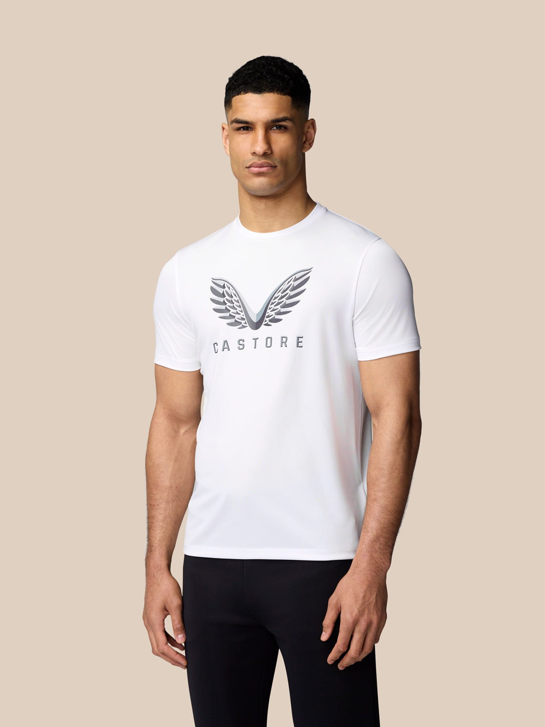 Model wearing white short sleeve graphic T shirt with Castore wings logo on chest