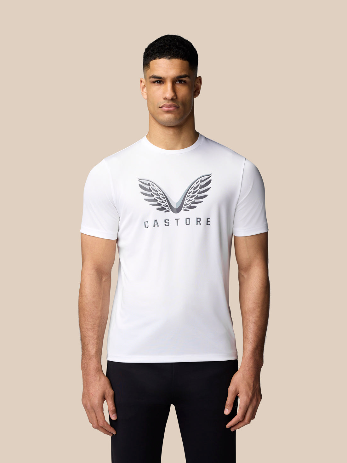 Male model wearing white graphic training T-shirt with Castore wings logo on chest