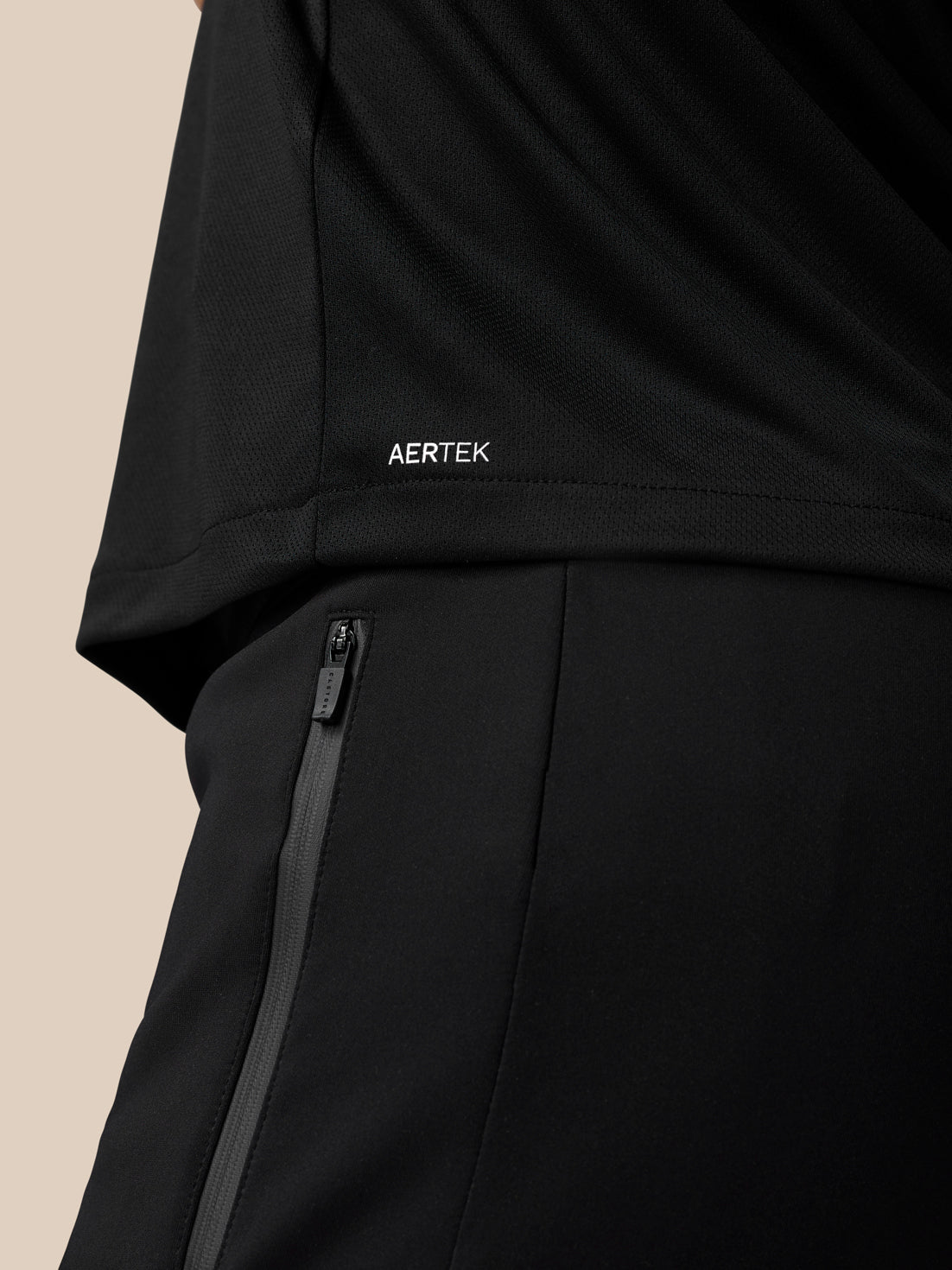 Close up of black Graphic Training T-Shirt showing Aertek branding at the lower back hem