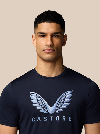 Close-up of navy Castore T-shirt with large light blue wings logo across the chest