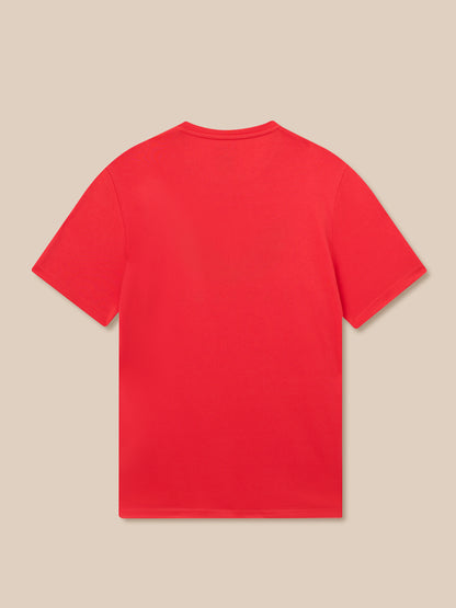 Back view of a bright red Poppy Red T-shirt laid flat on a beige background
