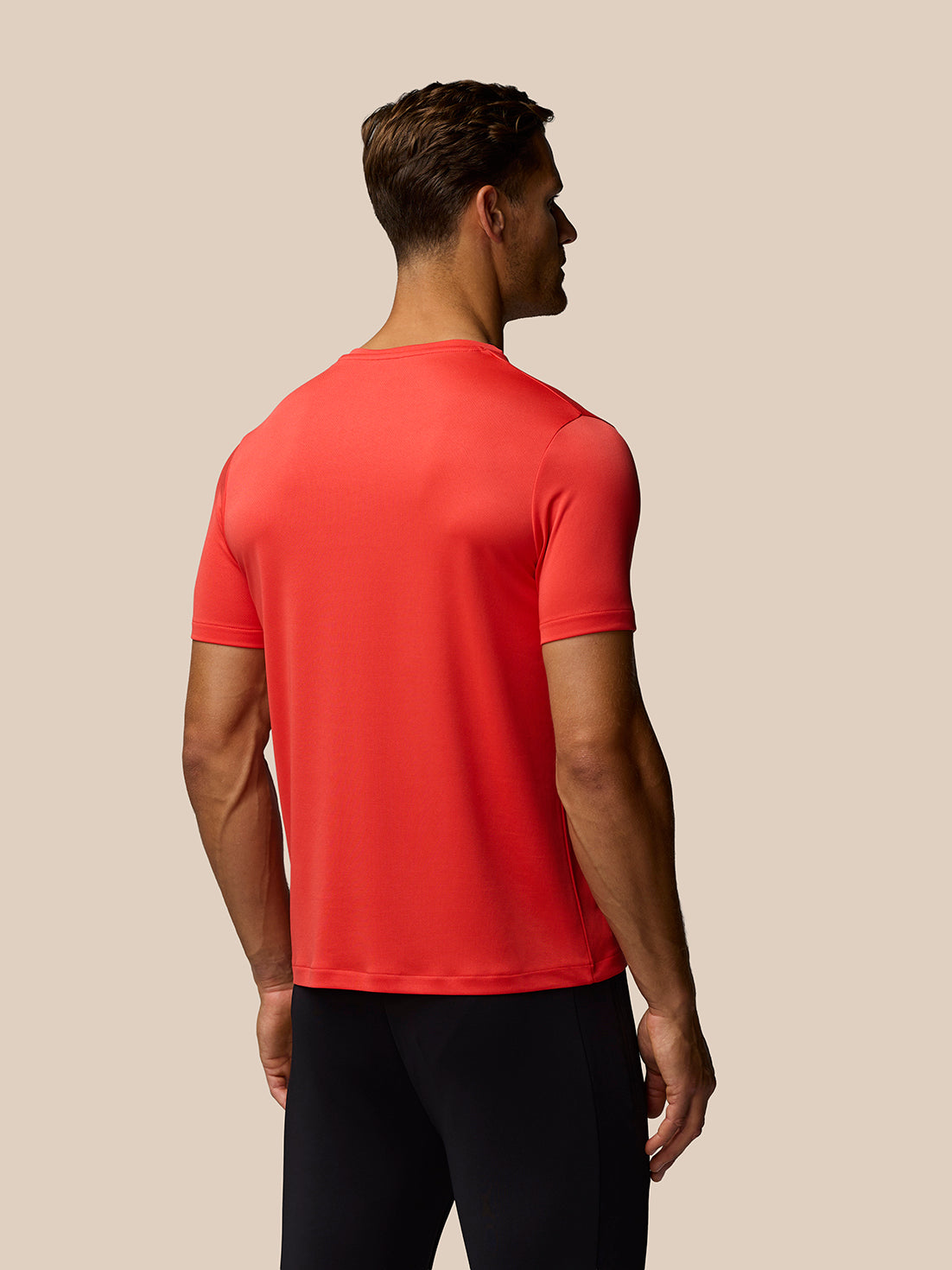 Back view of bright red Poppy Red short sleeve T-shirt on a model