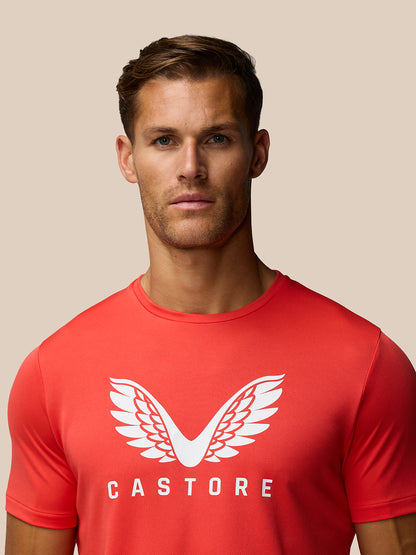 Male model wearing red graphic training T shirt with white wing logo and Castore branding