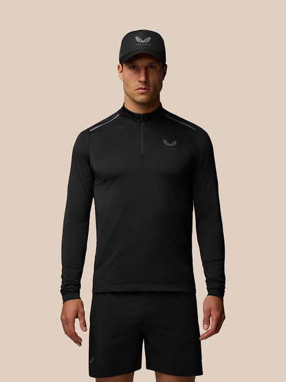 Male model wearing black Apex Training 1/4 Zip Top with stand collar and left chest logo