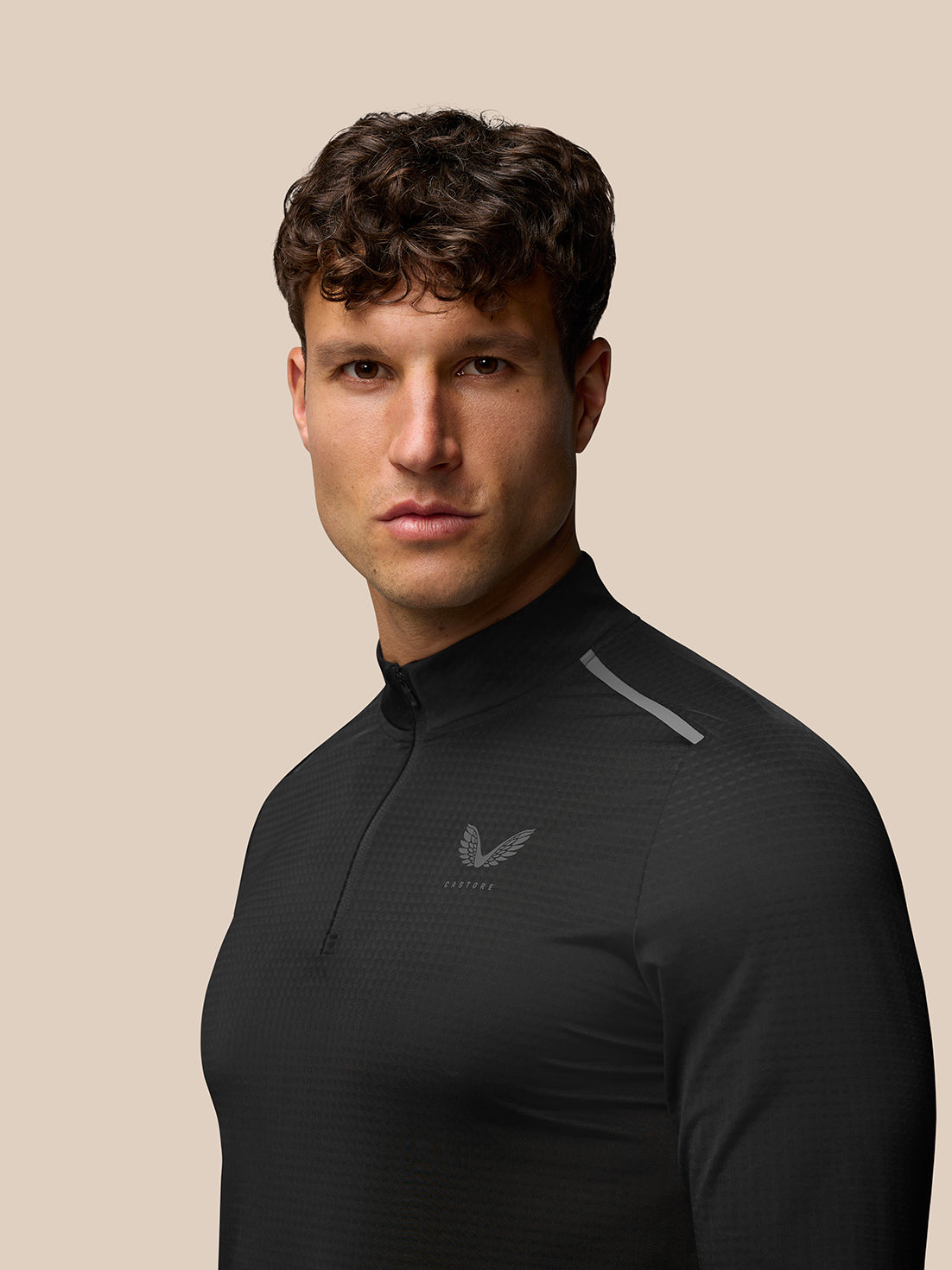 Three quarter rear view of black Apex Training top with reflective shoulder stripe