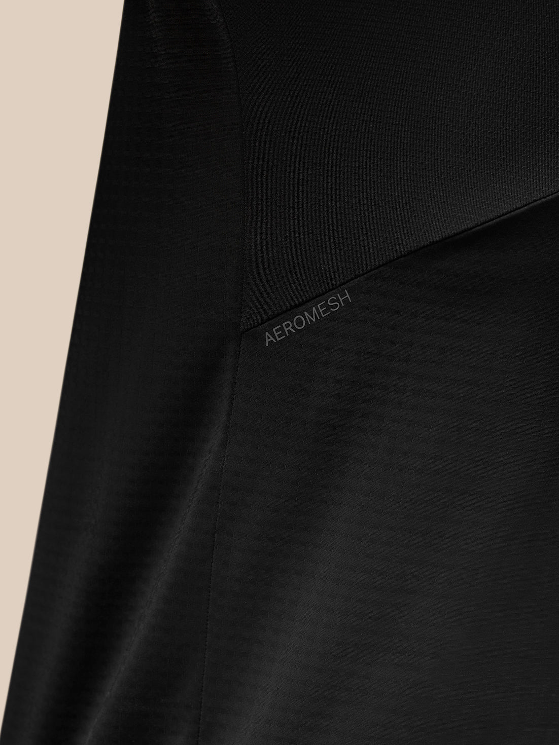 Close-up of black Apex Training top highlighting Aeromesh panel and textured fabric.