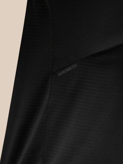 Close-up of black Apex Training top highlighting Aeromesh panel and textured fabric.