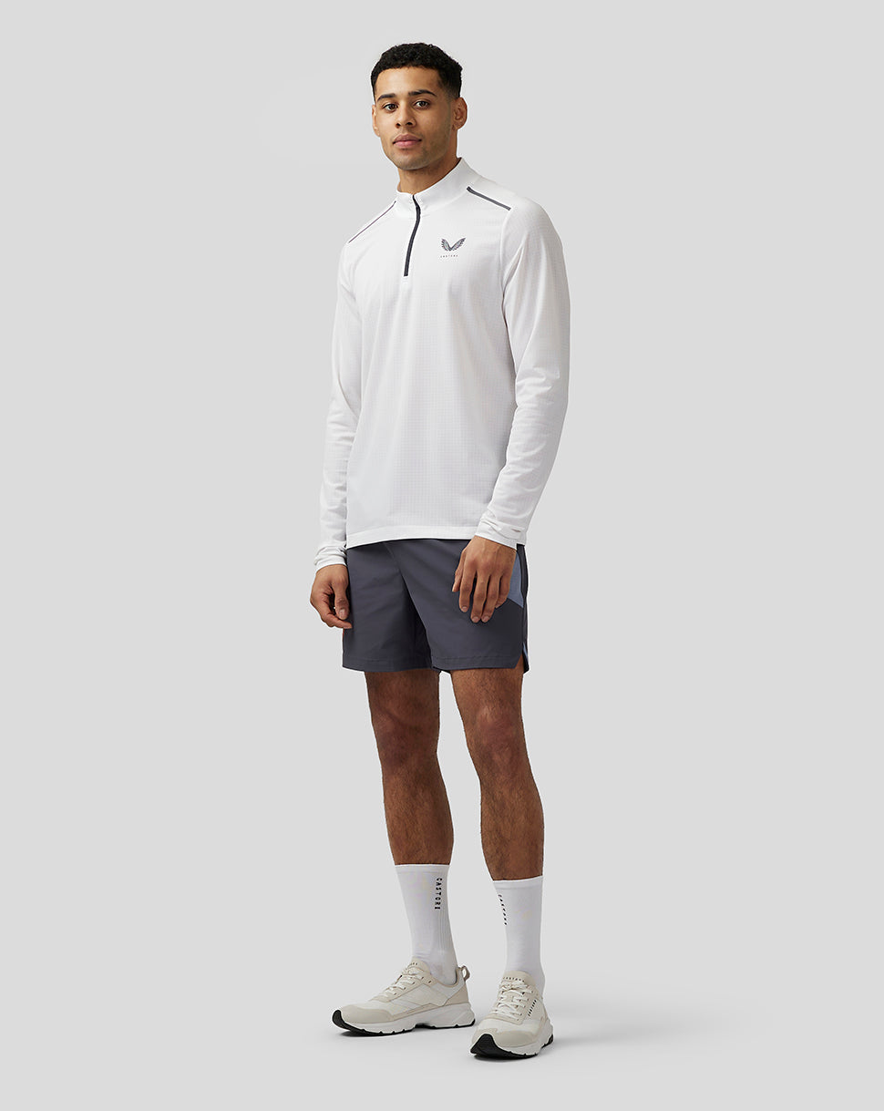 Rear three-quarter view of white Apex Training top showing dark panels and vertical Castore branding