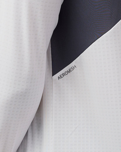 Front view of male model wearing white Apex Training 1/4 zip top with stand collar and chest branding