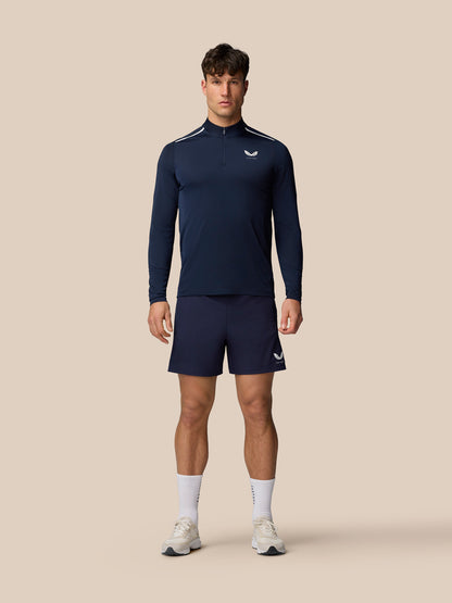 Male model wearing midnight navy Apex training long sleeve top with white shoulder stripes and matching shorts.