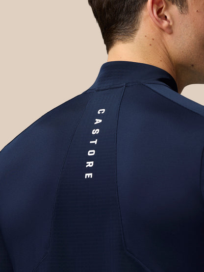 Midnight Navy Apex Training 1/4 Zip Top on a model, back view with Castore vertical branding along the shoulder seam