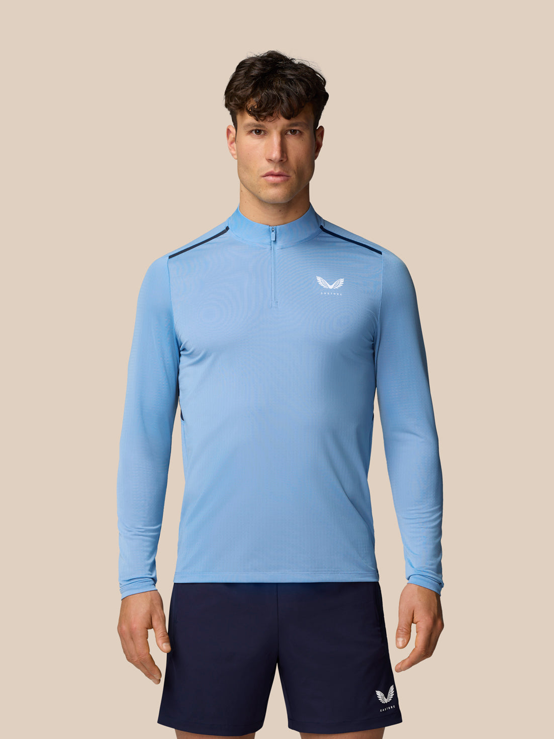 Men's Apex Training 1/4 Zip Top in sky blue worn by a model with a center front zip and small chest logo